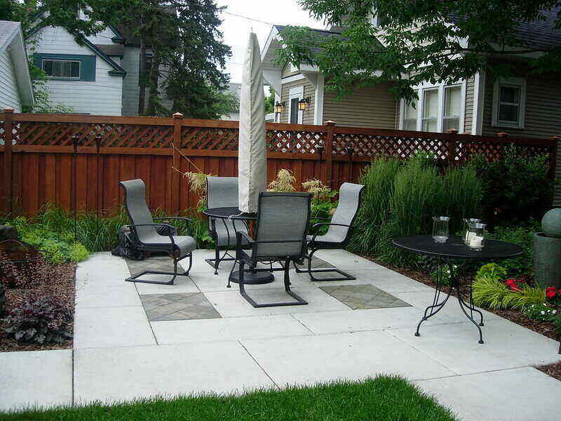 Large concrete patio with a bistro set and umbrella